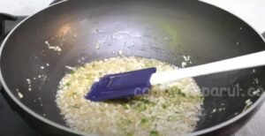 frying garlic, ginger, finely chopped green chilies in a  pan for manchurian recipe 
