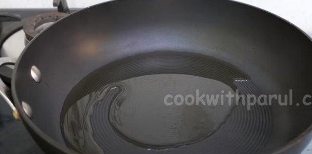 heating oil in a pan for veg momos recipe 