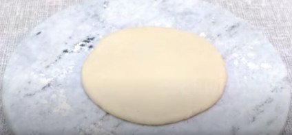 one rolled pizza on a rolling board for pizza recipe 