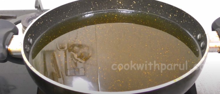 heating oil in a pan for kala gulab jamun recipe 