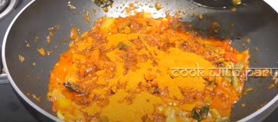 adding sambar masala powder in the pan for sambar recipe 