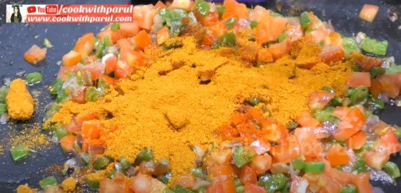 adding masala powder on vegetable for Masala Pav Recipe